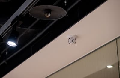 Security camera mounted in facility