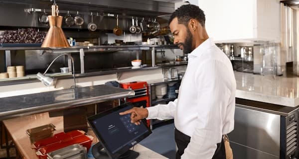 Food safety inspector using tablet in commercial kitchen
